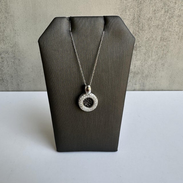 Add a touch of modern elegance to your jewelry collection with this exquisite 14kt White Gold Black and White Diamond...