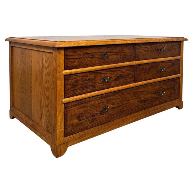 A handsome and beautifully crafted vintage 20th-century low chest of drawers, finely constructed in oak and distinguished...