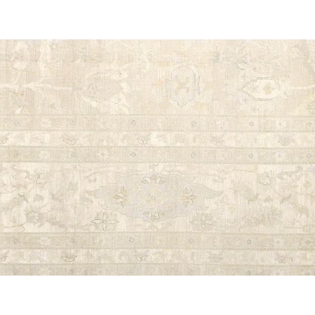 This Vintage Persian Tabriz Rug measures 9'9" x 14'2" and is hand woven with wool on a cotton foundation in the Tabriz...