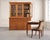 A handsome 20th century Georgian style country English pine bookcase cabinet featuring astral glazed glass doors....