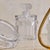 A French Robinson vanity set by Lalique, dating to the 1970s. This three-piece crystal ensemble includes a perfume...