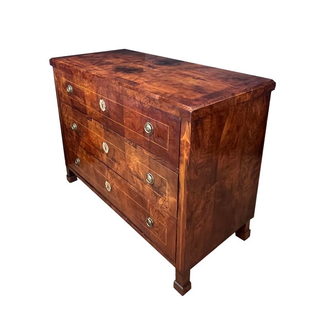 the rectangular top of book-matched veneer above a body fitted with three long well-figured mirror-veneered drawers...
