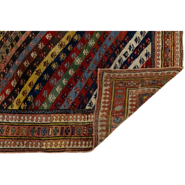 This beautiful vintage Persian rug features a hand-knotted wool design with a vibrant multicolor field. Adorned with a...