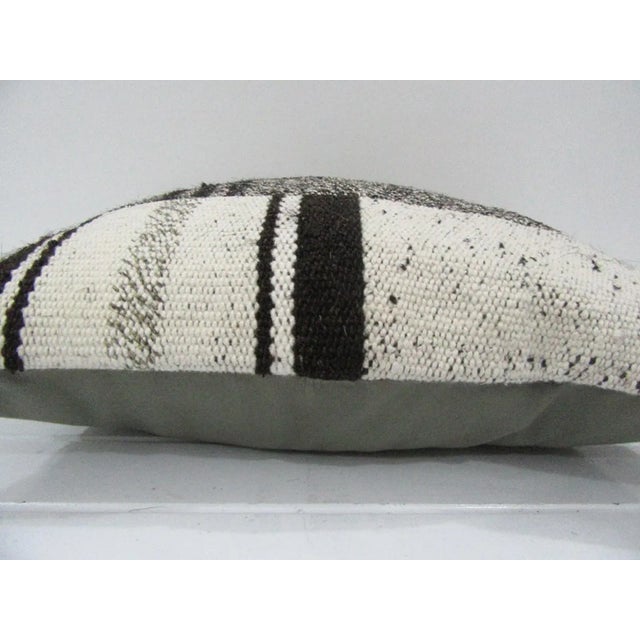 This is a pillow cover made from a vintage kilim rug. The piece was properly washed and ready to use. Pillow inserts not...