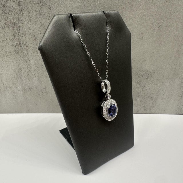 This elegant tanzanite and diamond necklace in 14kt white gold features a stunning 1.15 carat oval tanzanite accented by...