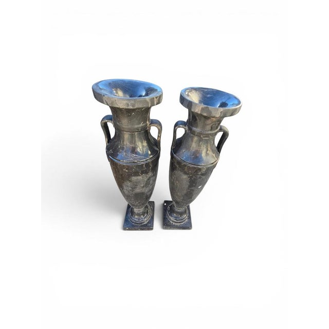 Elegant pair of large Greek-style vases carved in black marble during the 20th century. Inspired by the refined forms of...