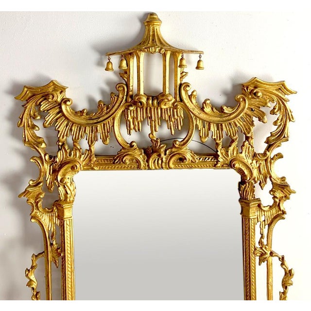 Large George III style Chippendale hand-carved wood pagoda wall mirror. Crafted from pine, this monumental mirror is...