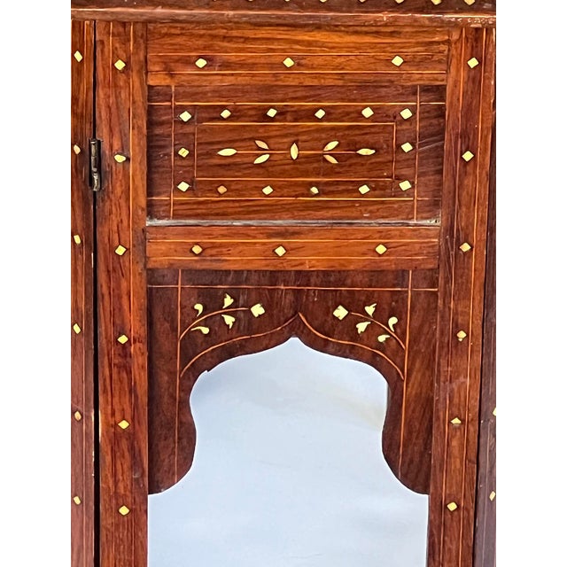 originally used as traveling tea tables for the British in India; the octagonal top centering a large stylized floral...