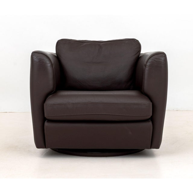 Roche Bobois Brown Leather Swivel Club Chair, on circular base with "Roche Bobois" label. 26" H x 30" W x 34" D; seat: 20"...