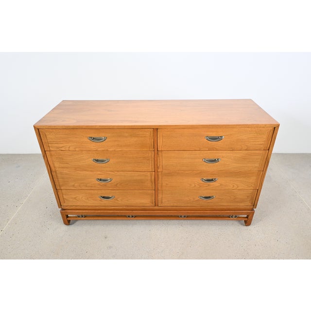 This Mid-Century Modern oak dresser channels the timeless style of Michael Taylor, featuring clean lines and a beautiful...