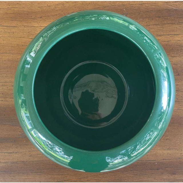 This glazed ceramic vase in the Art Deco Revival style pops with a glossy forest green finish and a classic postmodern...