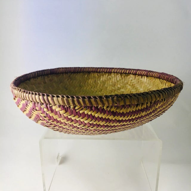 This vintage Native American style hand woven basket is executed in a bold geometric design with a very tight weave. It is...