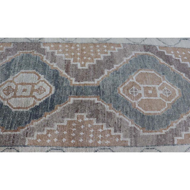 Measures: 2'10 x 26'0 Long Turkish Oushak Runner with Soft Green Field and Beige Medallions. Keivan Woven Arts. rug...
