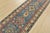 A tribal Caucasian Kazak runner hand-knotted with fine wool on a cotton foundation. This rug features a row of medallions...