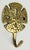 Vintage solid brass hook with coastal sand dollar motif. Patina to brass.