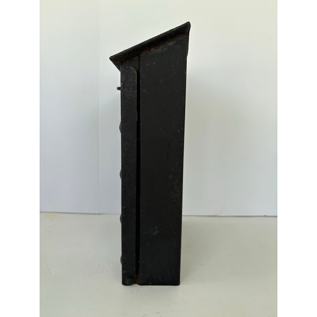This early 20th-century hand-forged metal wall mailbox features a wonderfully aged patina and a distinctly rustic,...