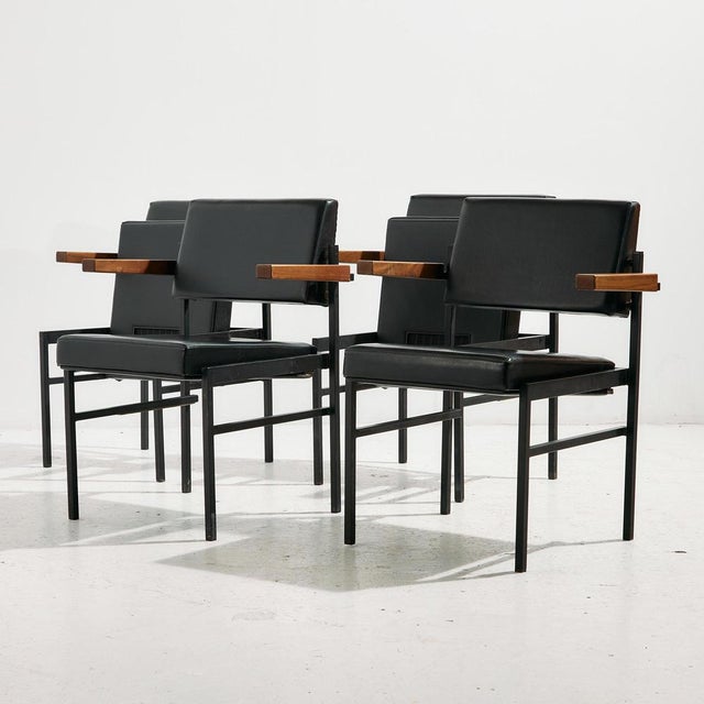 Metal frame armchair with leather upholstery and wooden armrests from the 1970s. The armchair seat can be folded down, but...