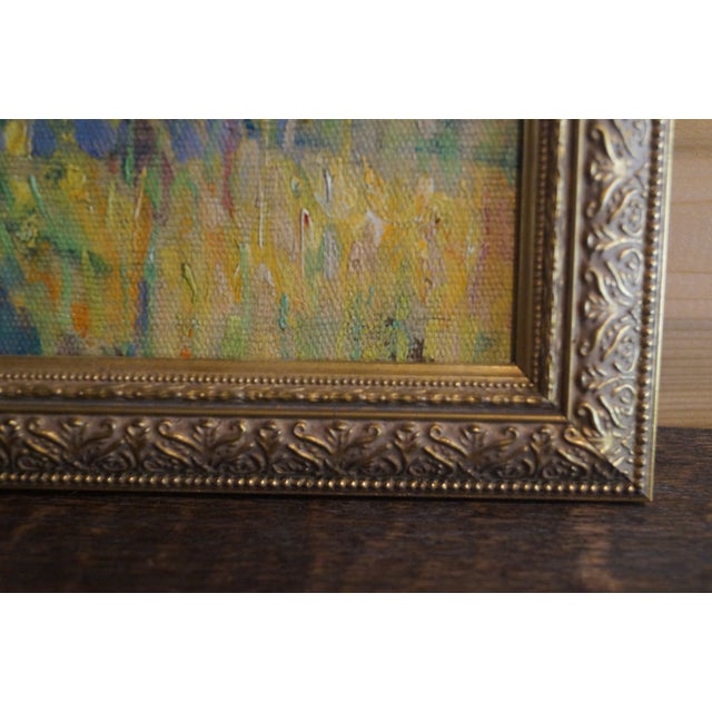 A 1930s landscape of trees which is framed in a "new" gold toned frame. The signature is obscured beneath the frame, and...