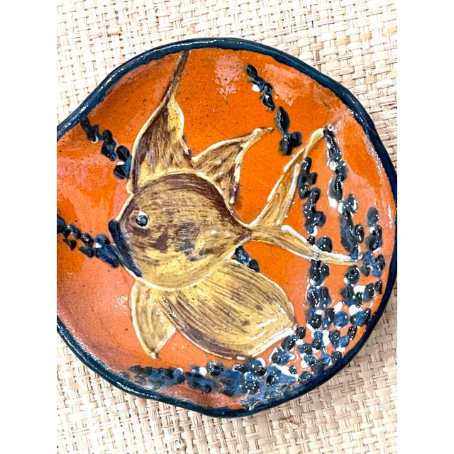 Vintage glazed terracotta vide poche. Made in Italy. Umber orange with blue coral and fish.