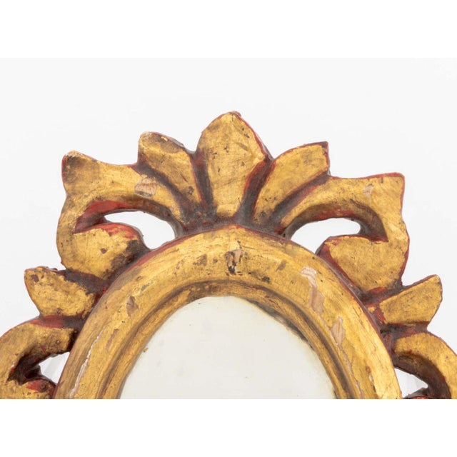 Baroque Style Giltwood Framed Small Mirror, the reticulated frame gessoed and gilded with red lacquer. Mirror plate: 7.5"...