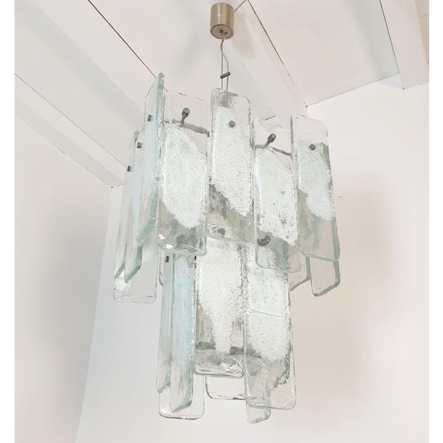 Large Mid Century Modern geometrical Murano glass chandelier after Mazzega, Italy 1970s. The vintage pendant chandelier is...