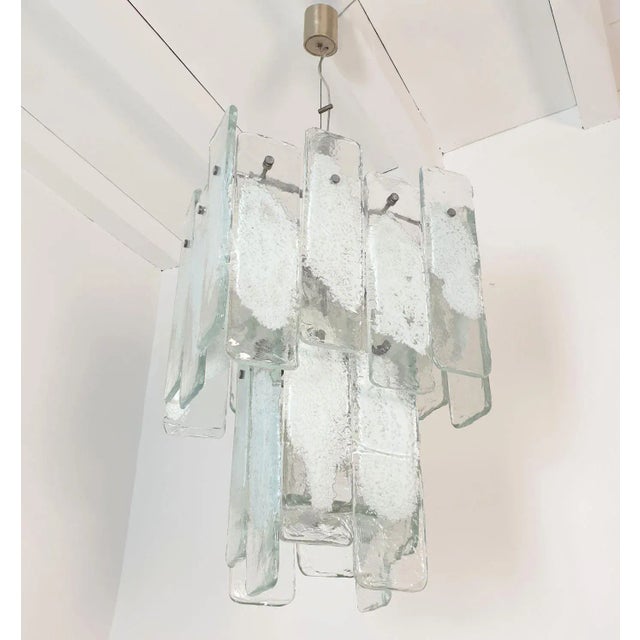 Large Mid Century Modern geometrical Murano glass chandelier after Mazzega, Italy 1970s. The vintage pendant chandelier is...