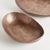 This pair of handcrafted bowls has simple oval silhouettes, with a copper finish and subtle texture. They can be styled...