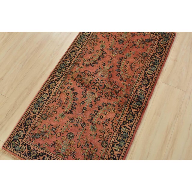 A traditional Sarouk rug hand-knotted with an all-wool pile on a cotton foundation. This finely woven oriental rug...