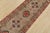 A tribal Caucasian Kazak runner hand-knotted with fine wool on a cotton foundation. This rug features geometric medallions...