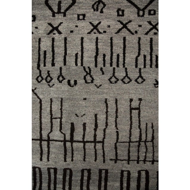 The CIRCUIT Abstract Grey and Black Moroccan Area Rug is a versatile piece that combines traditional Moroccan...