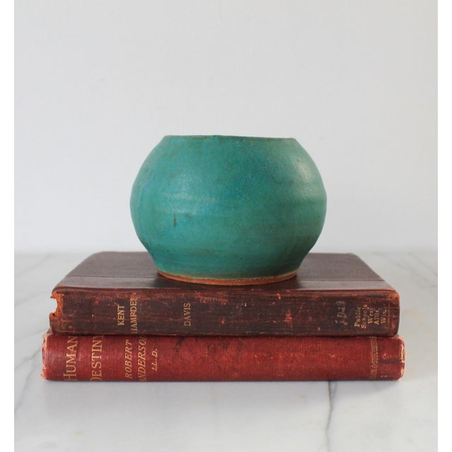 Vintage teal colored studio art pottery vessel. Signed by the artist on bottom. Minor age wear. No chips or cracks. Some...