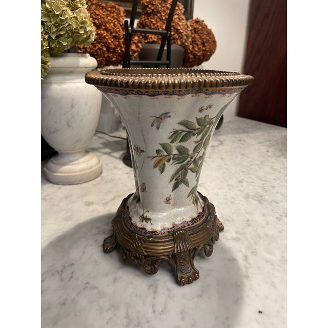 Beautiful Chinese porcelain vase by Wong Lee, with painted motif of birds, branches and leaves, atop a pedestal of bronze...