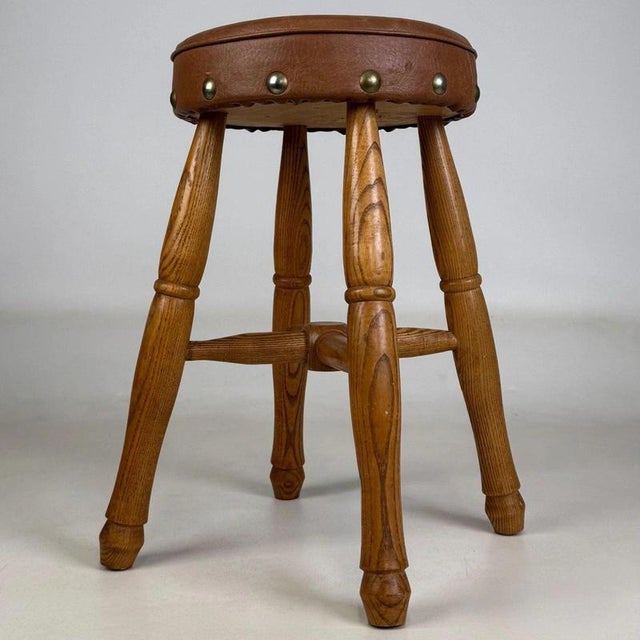 A beautifully crafted 20th-century oak stool, exceptionally well made and distinguished by its sturdy construction,...