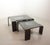 A stunning black lacquered coffee table, constructed rom four bent plywood panels, seamlessly forming both tabletop and...