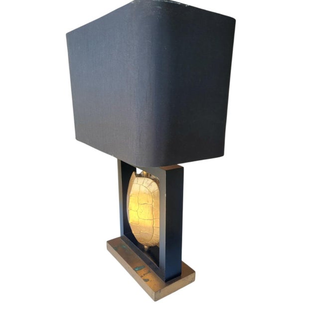 A wonderful very chic gold gilt turtle shell brass base table lamp. The lamps features a black rectangular shade with a...