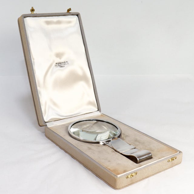 By Ravinet d'Enfert for Hermès Paris. In solid silver. The handle of the magnifier in the form of a belt buckle. Together...