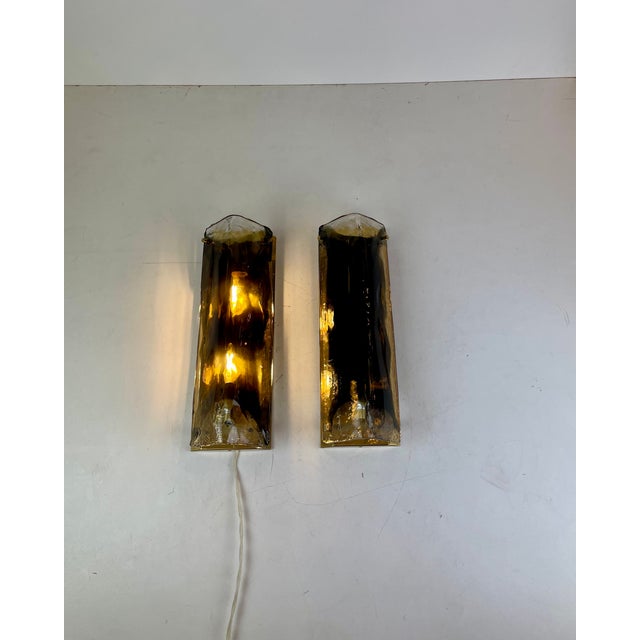 Beautiful set of two wall lamps, sconces, made of a plied piece of clear murano glass with dark cloud (which was probably...
