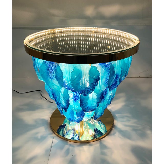Modern Italian illuminated table with infinity lit mirror, dressed with blue and aquamarine Murano glass leaves mounted on...
