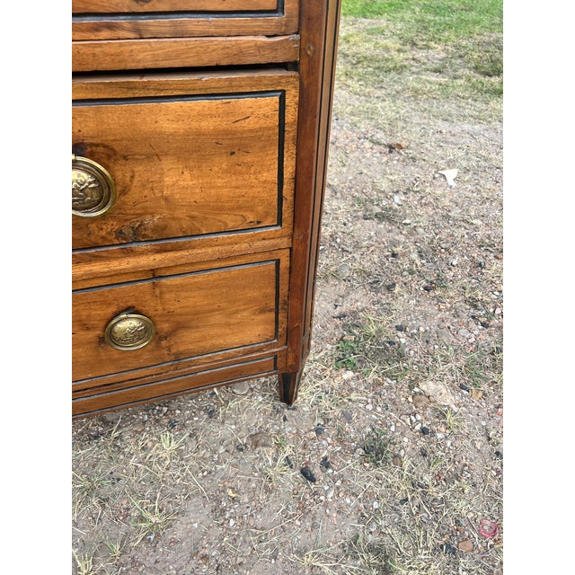 A charming 19th-century French Louis XVI commode, crafted in solid walnut with beautifully figured walnut veneer. This...