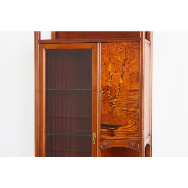 An exceptional Art Nouveau display cabinet by Louis Majorelle, masterfully crafted in France around 1900. This elegant...