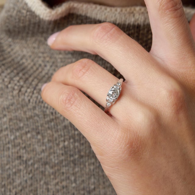 A refined emblem of 1930s sophistication, this authentic Art Deco engagement ring showcases a beautifully cut 0.59 carat...