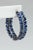 An amazing pair of hoops with a double row of faceted, oval kyanite gemstones with a double row of of round, brilliant cut...