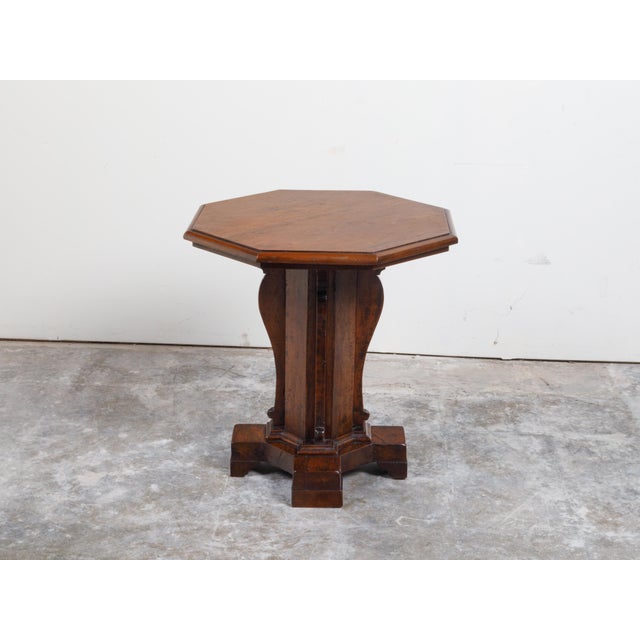 An Italian walnut side table from the 19th century, with octagonal top and pedestal base. Created in Italy during the 19th...