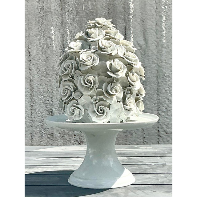 An exquisite display of craftsmanship, this vintage Regency-style glazed porcelain rose cake is a true statement piece....