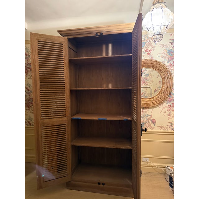 This is a fabulous armoir from Restoration Hardware = great condition except for slight warping on 2 of the shelves. A...