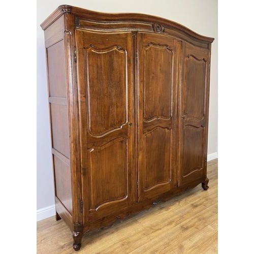 This elegant Vintage French Louis wardrobe showcases refined craftsmanship with beautifully shaped panel doors, graceful...