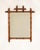 A decorative mirror featuring faux bamboo detailing, reflecting the period fascination with exotic motifs. The lightweight...