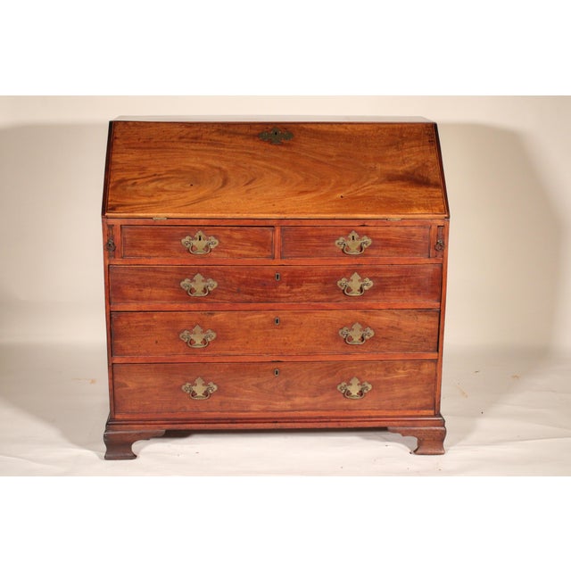 George II mahogany slant top desk, circa 1800. With a rectangular top, a nicely figured mahogany slant lid, the interior...