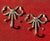 Pair of brass bow wall hooks. Each bow is crafted to resemble a ribbon tied into a classic bow shape, with loops on both...