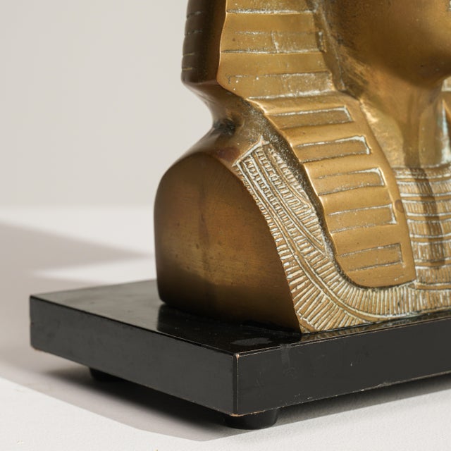 A decorative brass table lamp inspired by Egyptian Revival motifs popular during the Regency period revival. The...